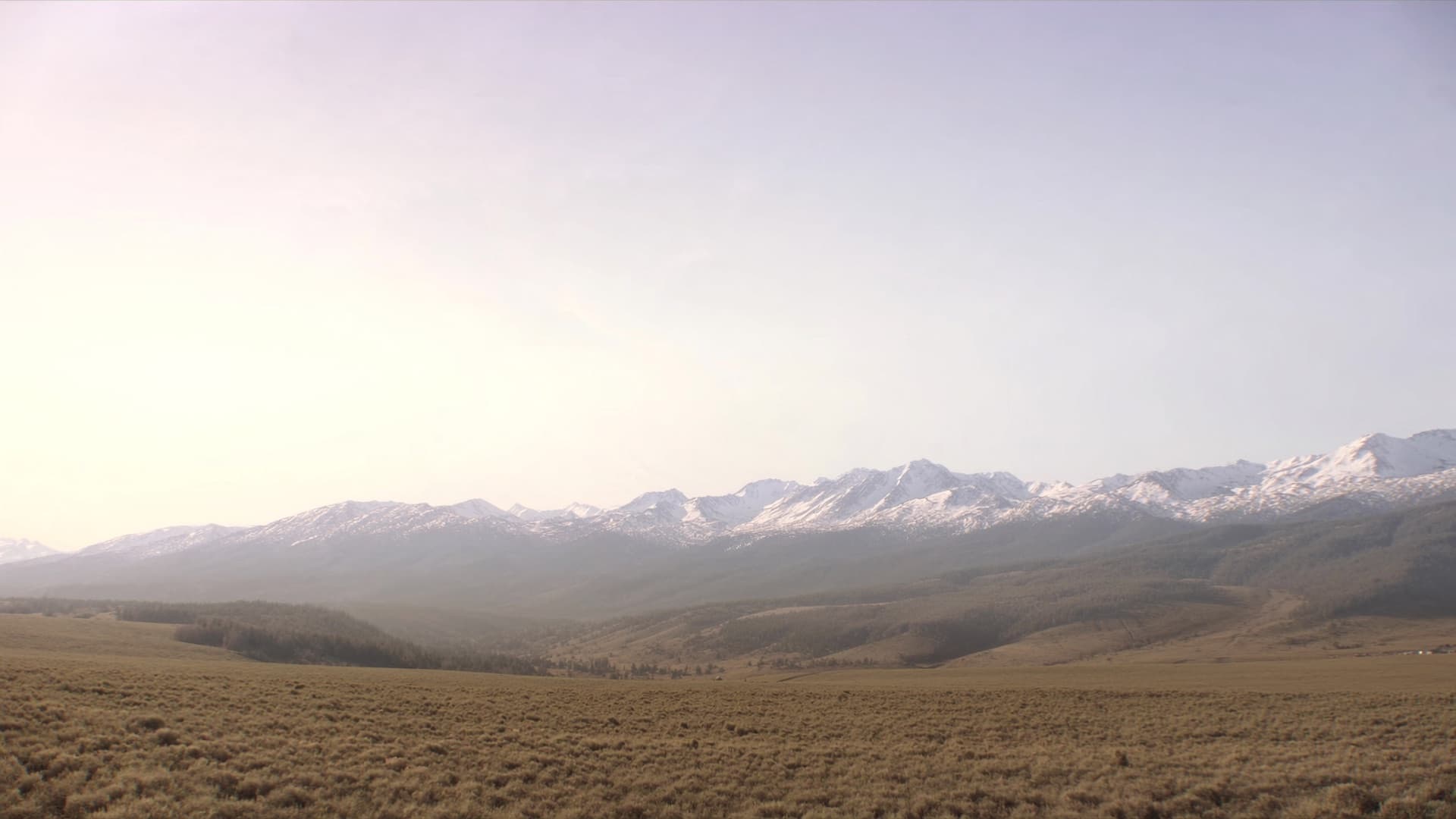 Wide Wyoming valley with distant snow-capped mountains